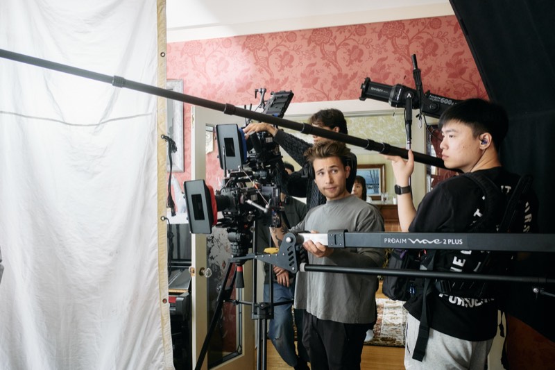Actors running a scene while the crew works around them.