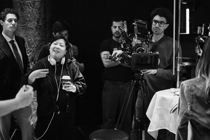 Behind-the-scenes view of a lit interior set during filming.