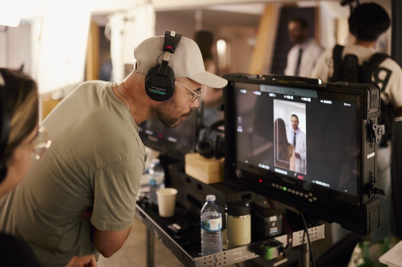 Actors running a scene while the crew works around them.
