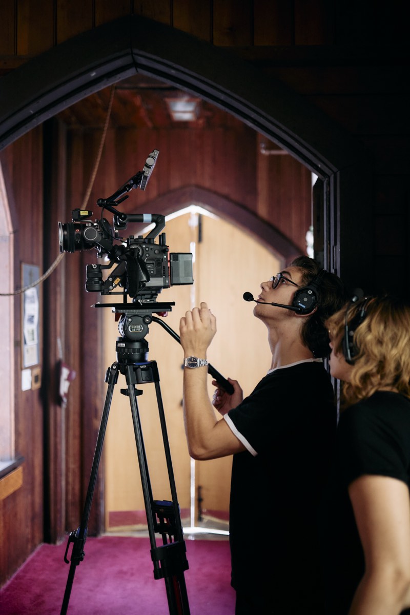 Behind-the-scenes view of a lit interior set during filming.
