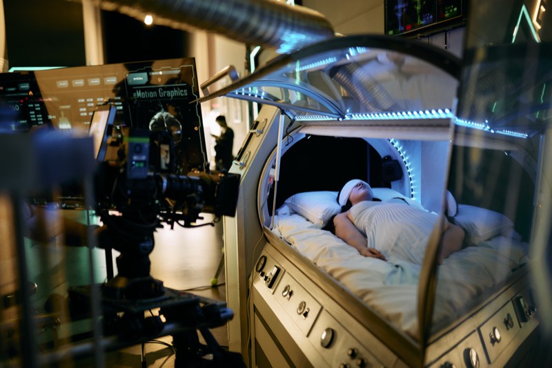 Actors running a scene while the crew works around them.
