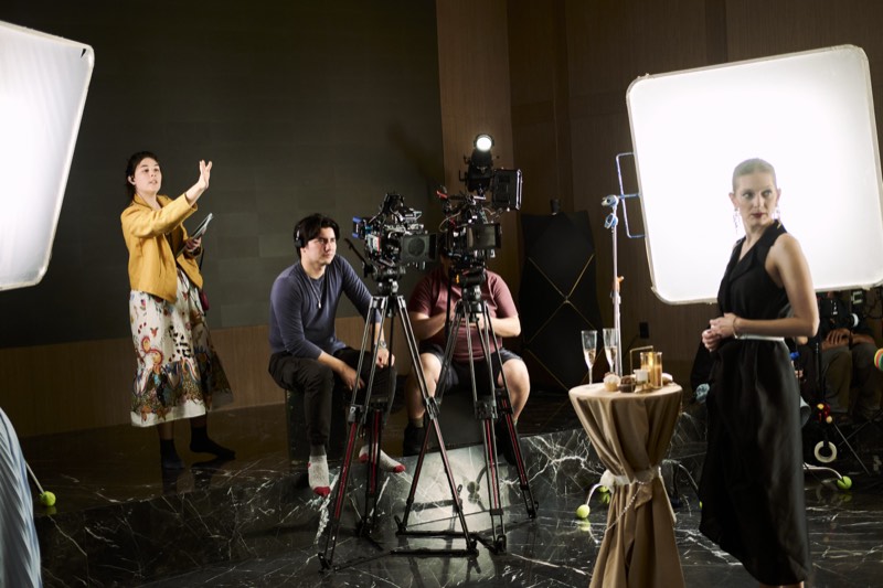 Actors running a scene while the crew works around them.