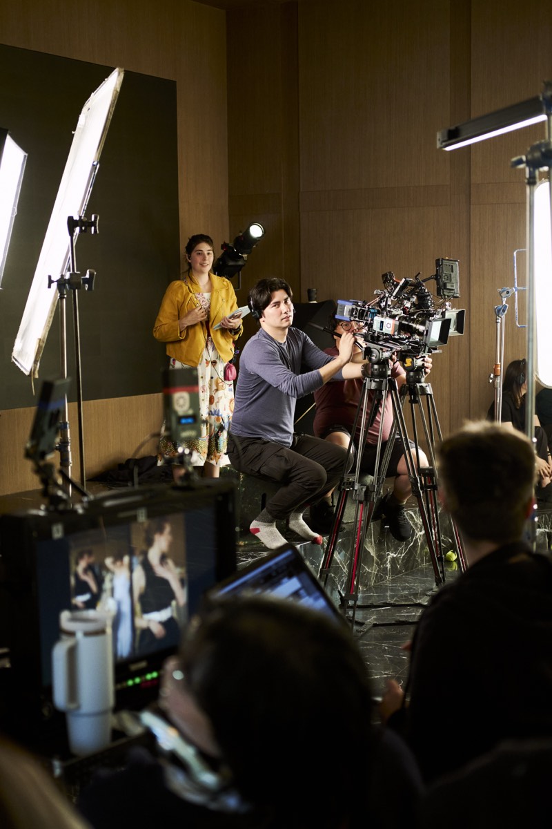 Behind-the-scenes view of a lit interior set during filming.