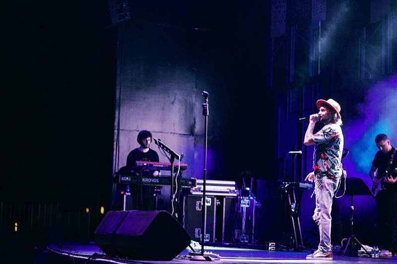 Band performing to a full room, shot from the photo pit.