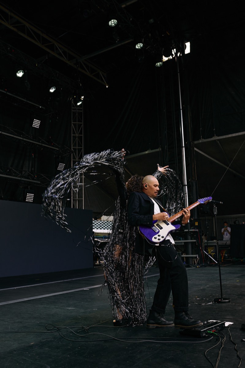 Performers on stage during a large ceremonial event.