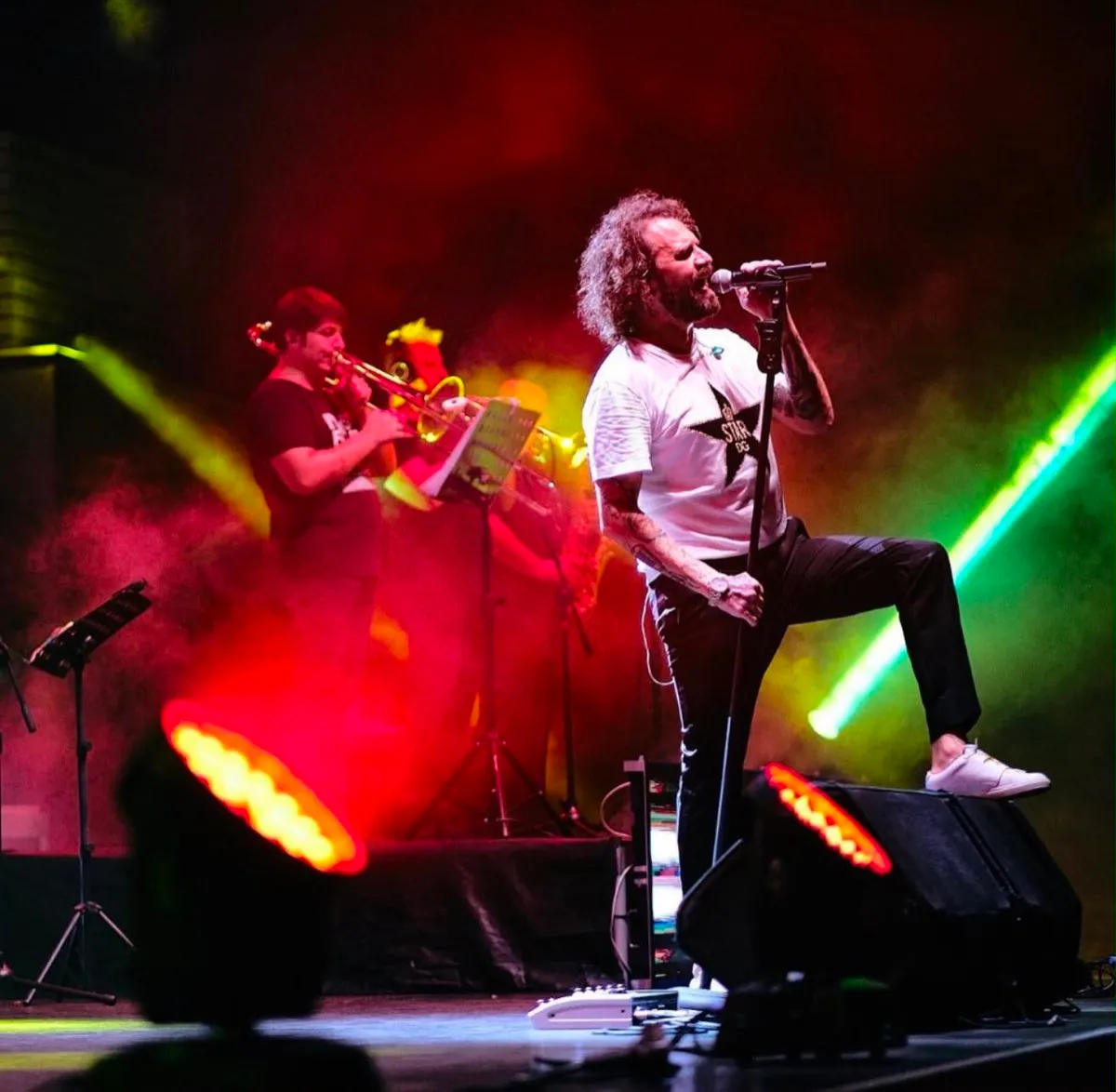 Performer under coloured stage lighting during a live concert in Vancouver.