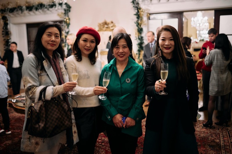 Candid moment between guests at a themed corporate party.