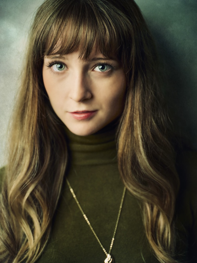Studio headshot of a woman against a softly textured backdrop, photographed in Vancouver.