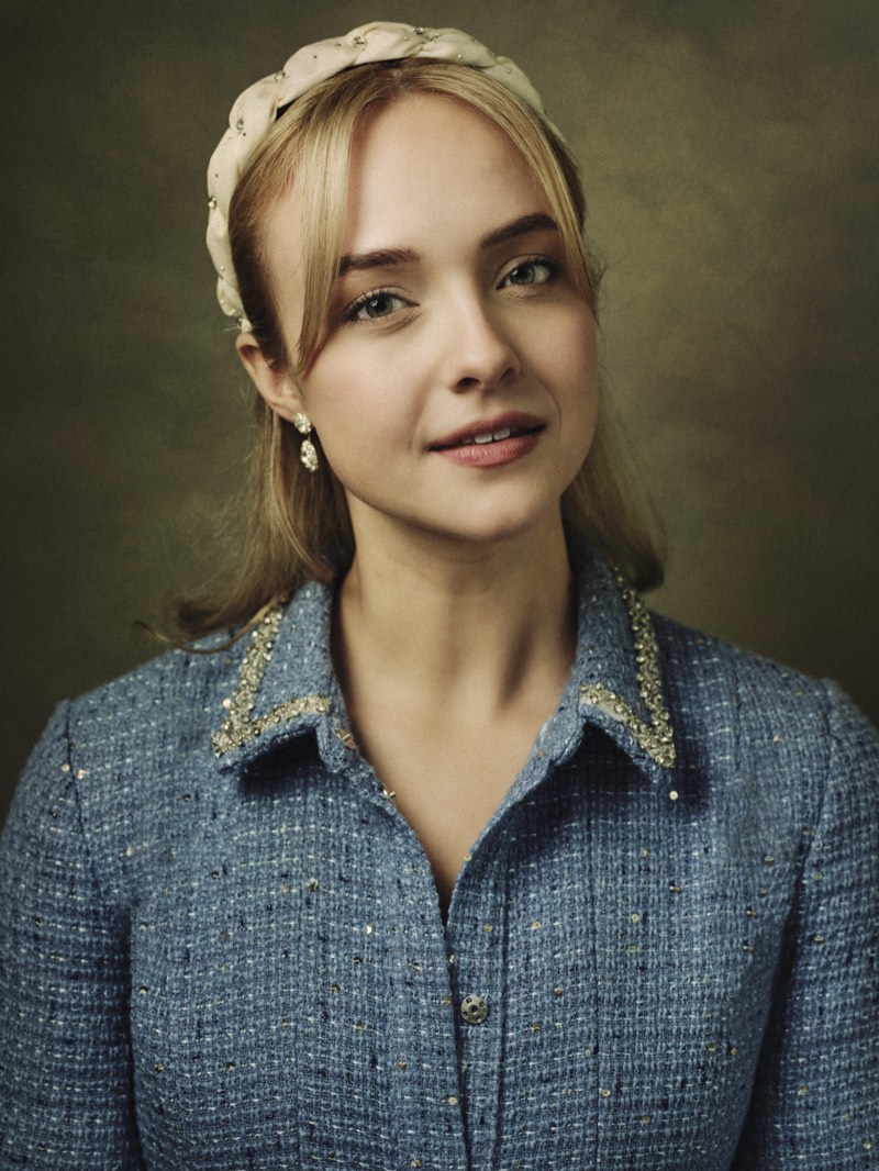 Professional portrait lit with a single soft key light, shoulders square to camera.