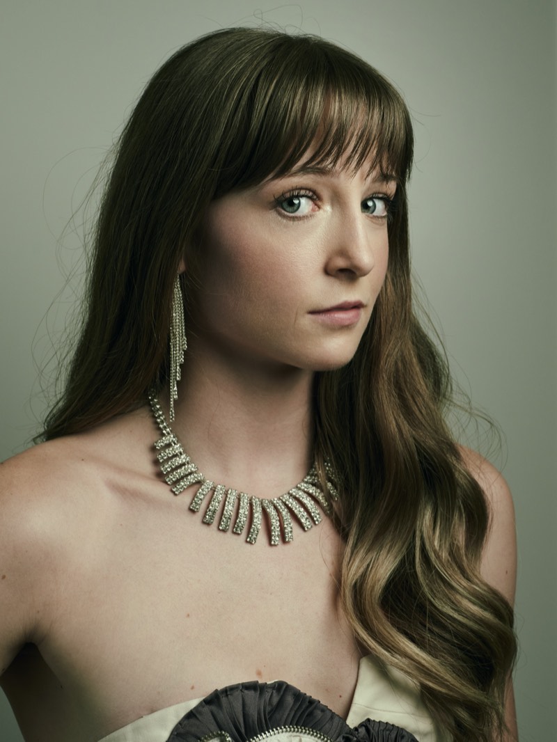 Corporate headshot on a neutral background, natural expression, waist-up framing.