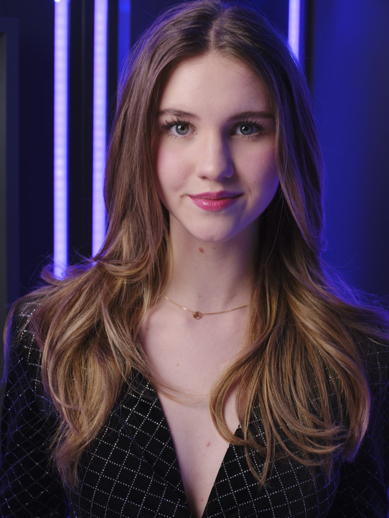 Corporate headshot on a neutral background, natural expression, waist-up framing.