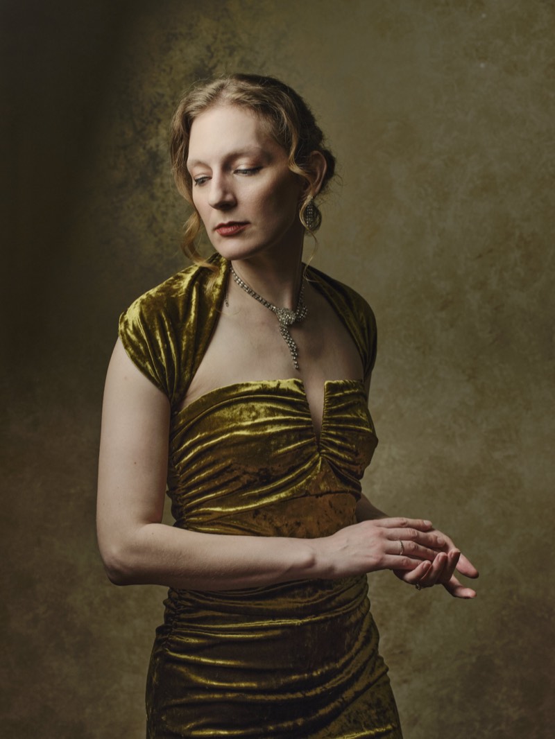 Editorial portrait with muted warm tones and a shallow depth of field.