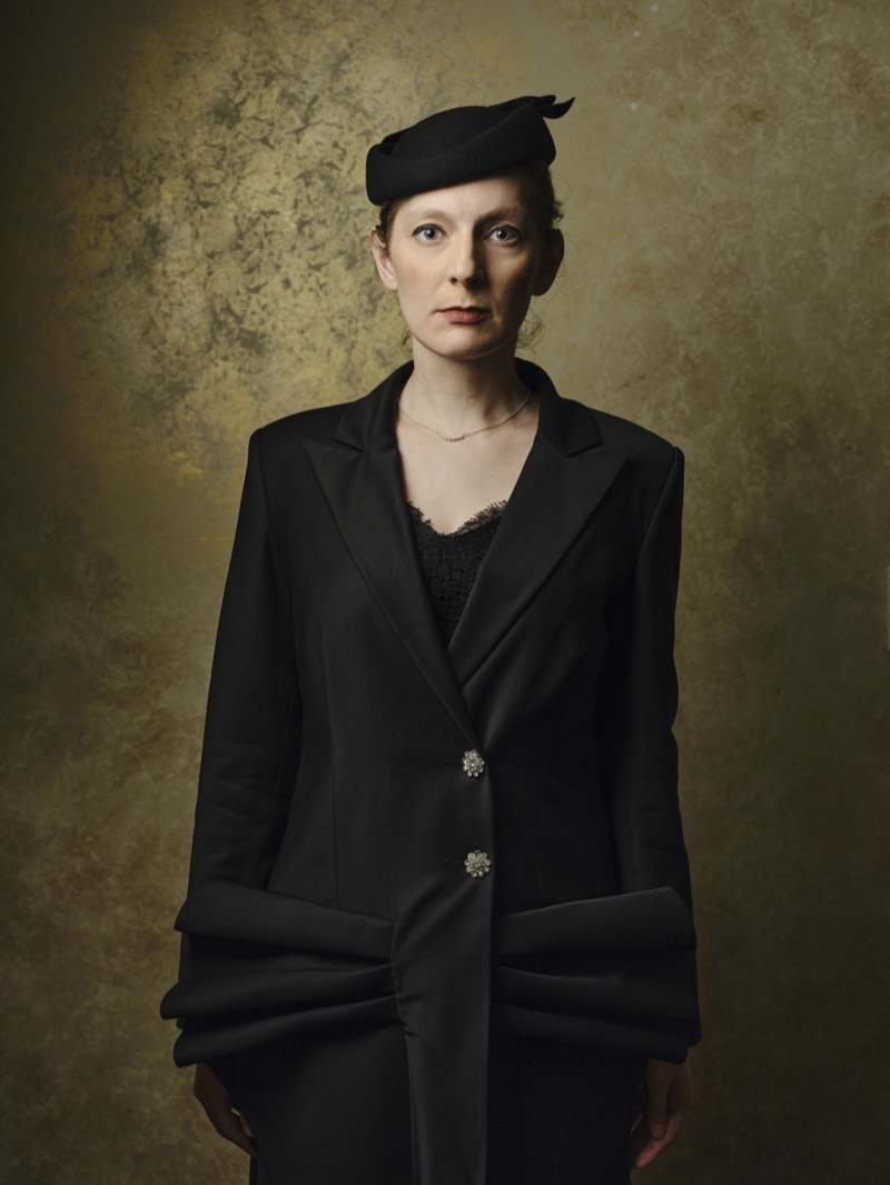 Corporate headshot on a neutral background, natural expression, waist-up framing.