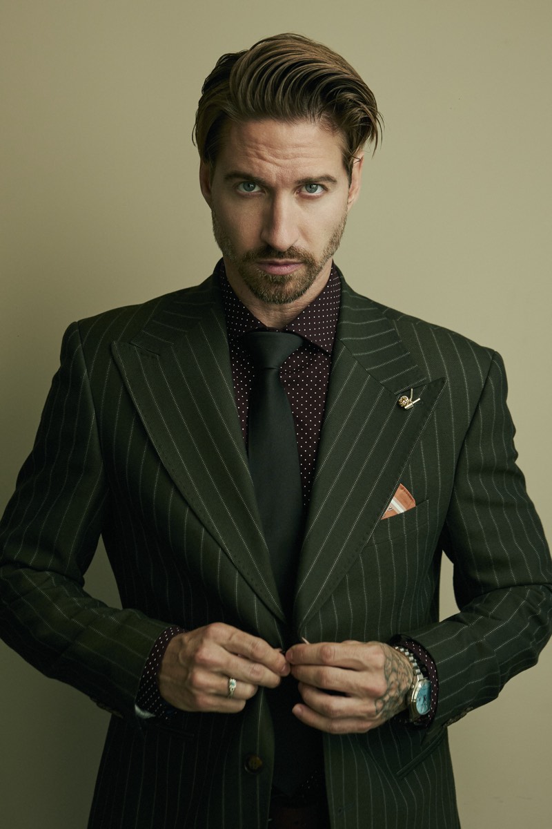 Professional portrait lit with a single soft key light, shoulders square to camera.