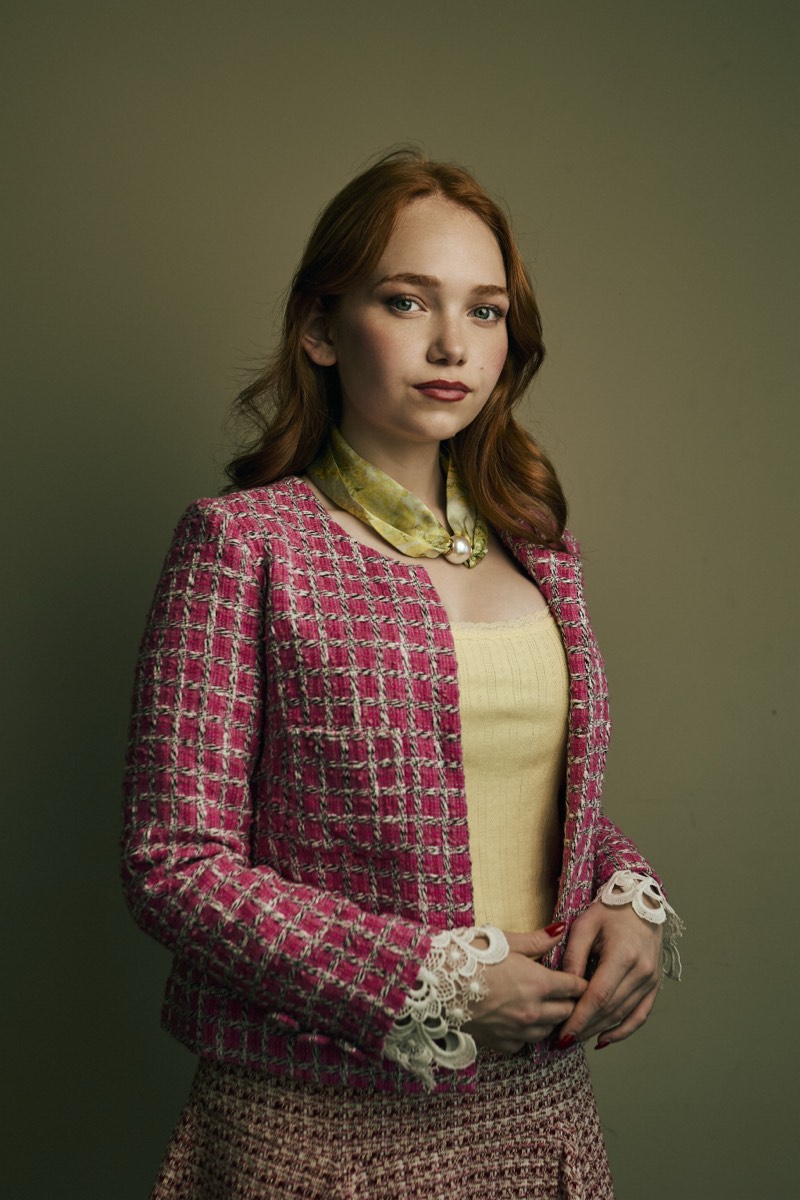 Corporate headshot on a neutral background, natural expression, waist-up framing.