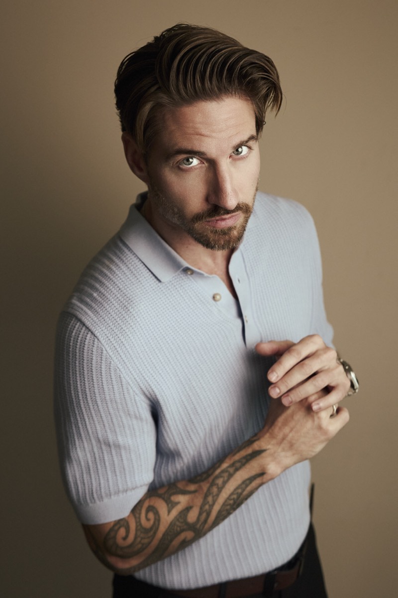 Professional portrait lit with a single soft key light, shoulders square to camera.