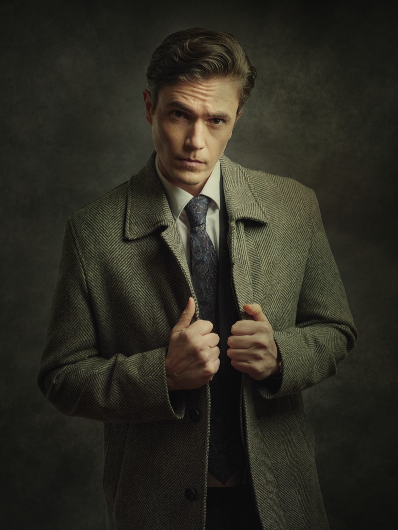 Editorial portrait with muted warm tones and a shallow depth of field.