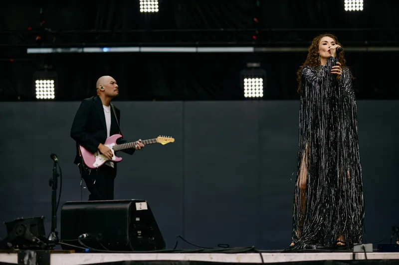 The two of them at the front of the stage, the guitarist on the pink guitar.