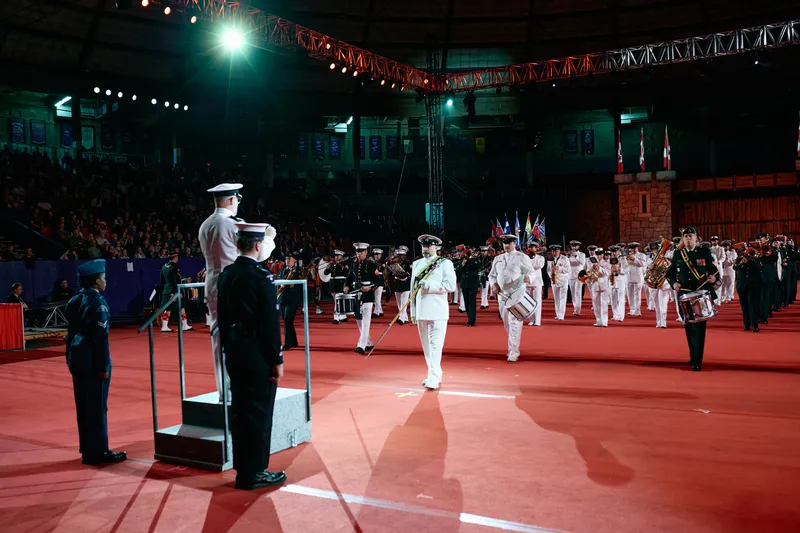Officers and a marching band enter the Agrodome floor past the saluting dais.
