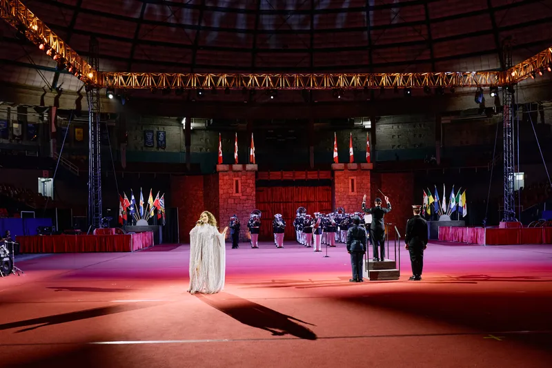 Wide view of the arena with MAKENZA at the centre and her shadow stretched across the floor.