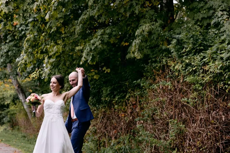 Olivia and James holding each other on the path after the first look.