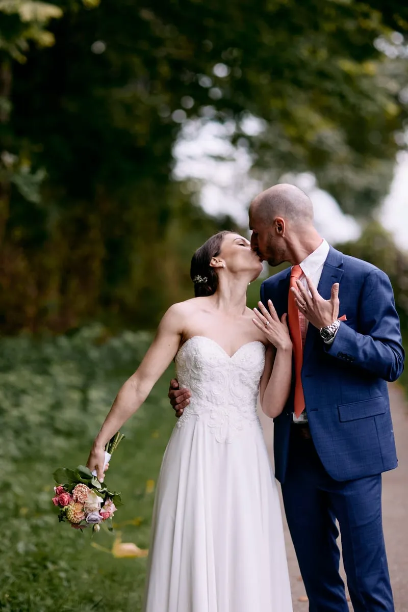 A kiss on the path, Olivia's hand on James's chest.