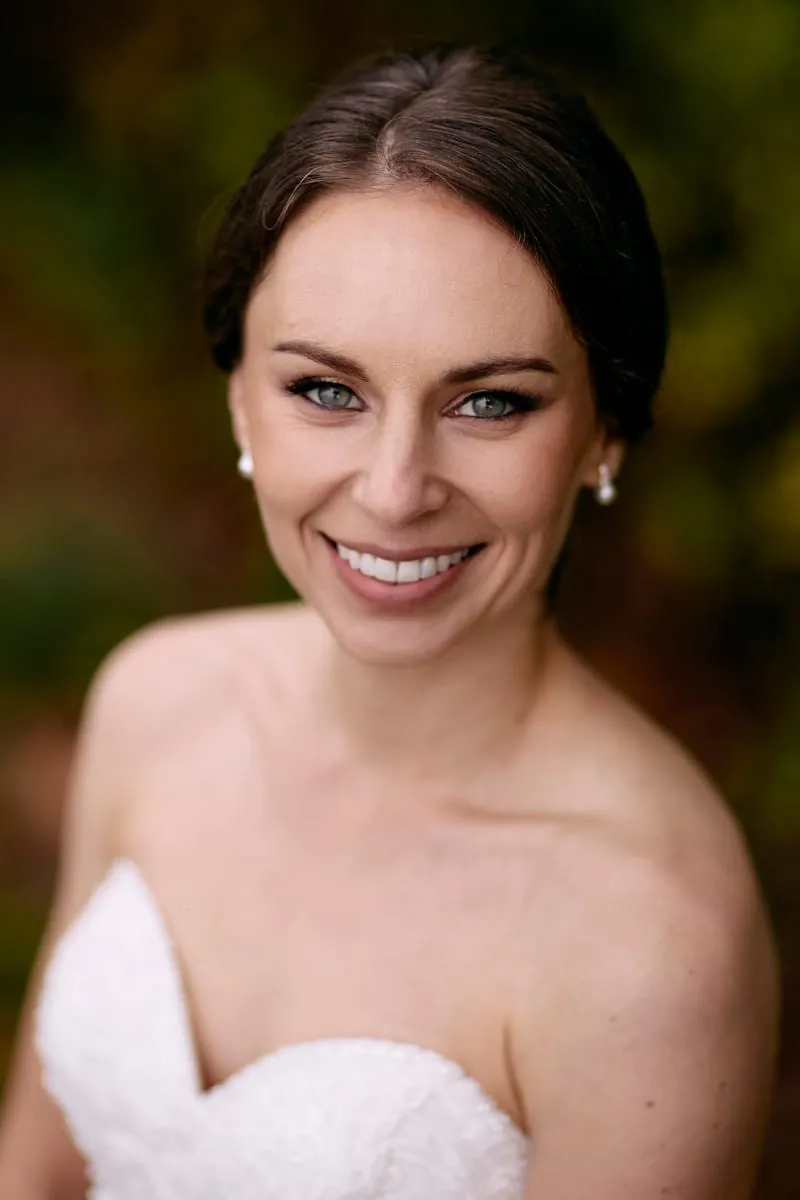 Portrait of Olivia in her dress, hair pinned up, smiling.