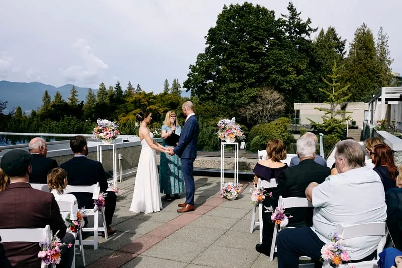 The ceremony on the terrace, guests seated, the mountains beyond.
