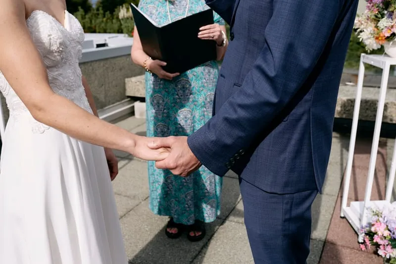 Olivia and James's hands as they take each other's.