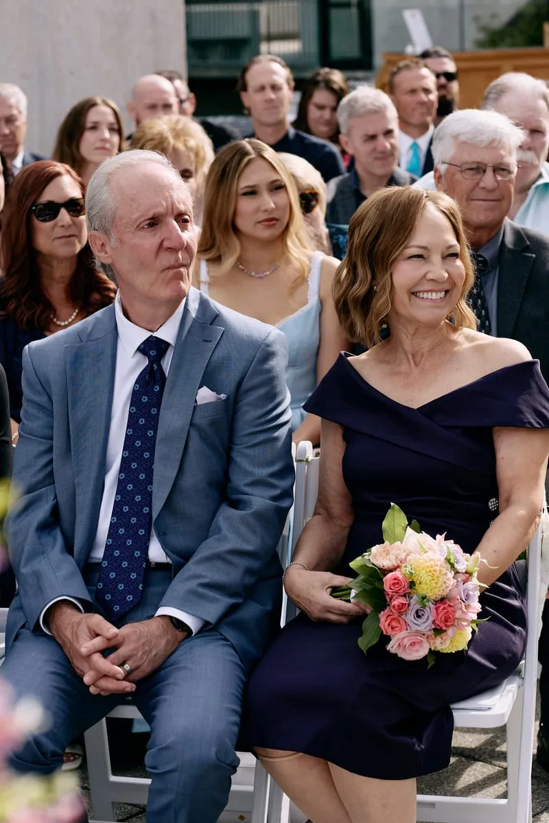 Parents in the front row, listening.