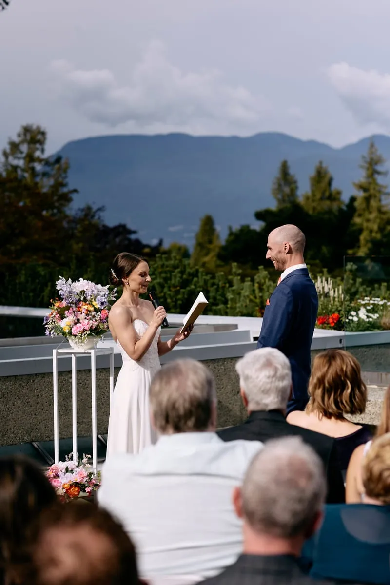 The couple at the front of the terrace under a wide grey sky.