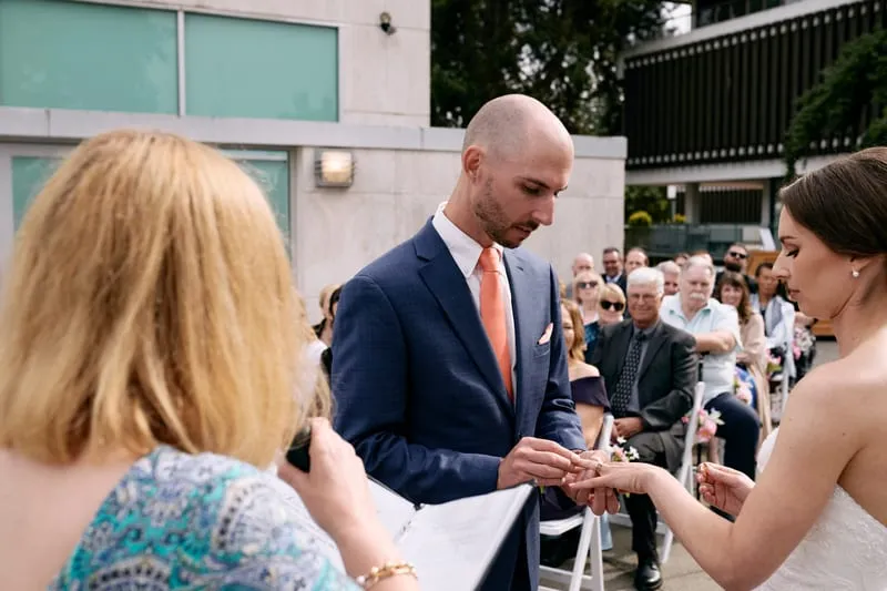 James sliding the ring onto Olivia's finger.