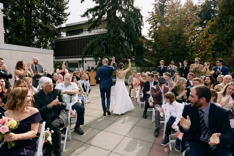 Olivia and James walking out through their guests.