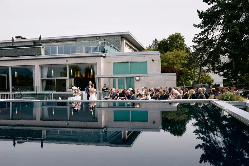 Guests reflected in the terrace pool after the ceremony.