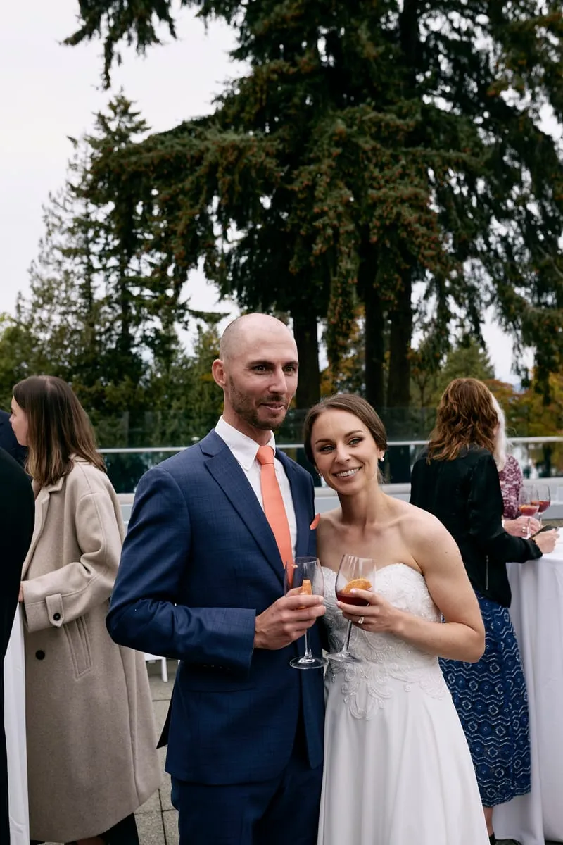 Olivia and James with drinks, talking with guests.