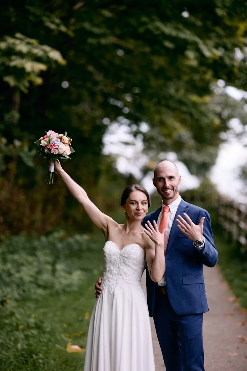 Olivia throws her bouquet high in the air while James shows off his ring.