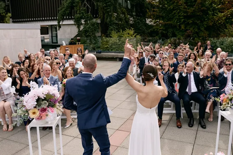 A high five over their heads as the guests cheer.