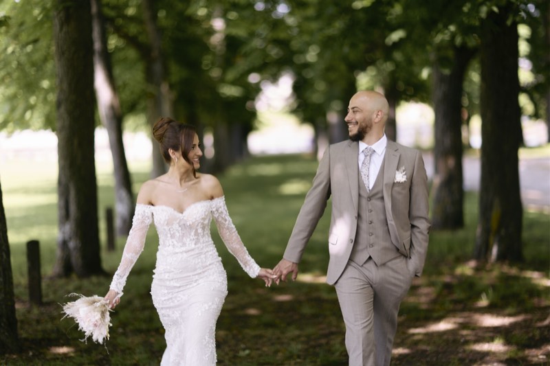Couple holding each other beneath an open sky.
