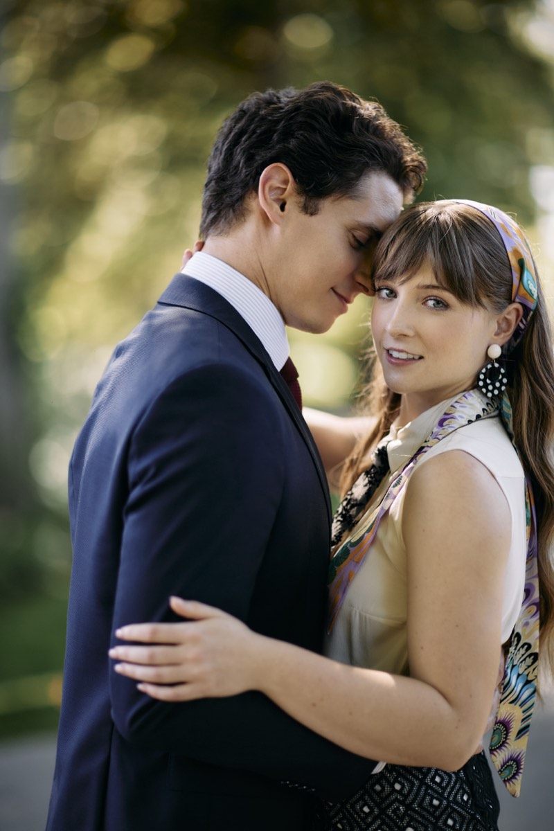 Couple holding each other beneath an open sky.