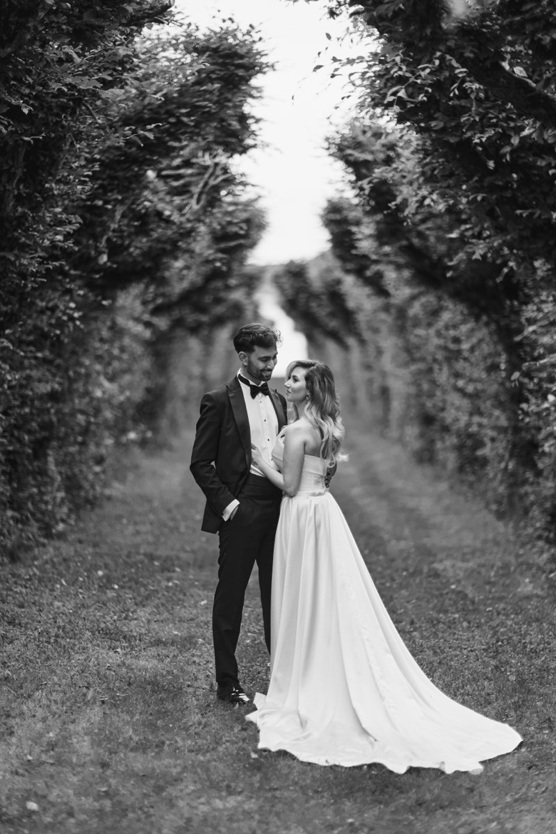 Couple holding each other beneath an open sky.