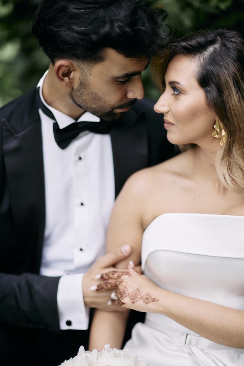 Groom fastening his cuff before the ceremony.