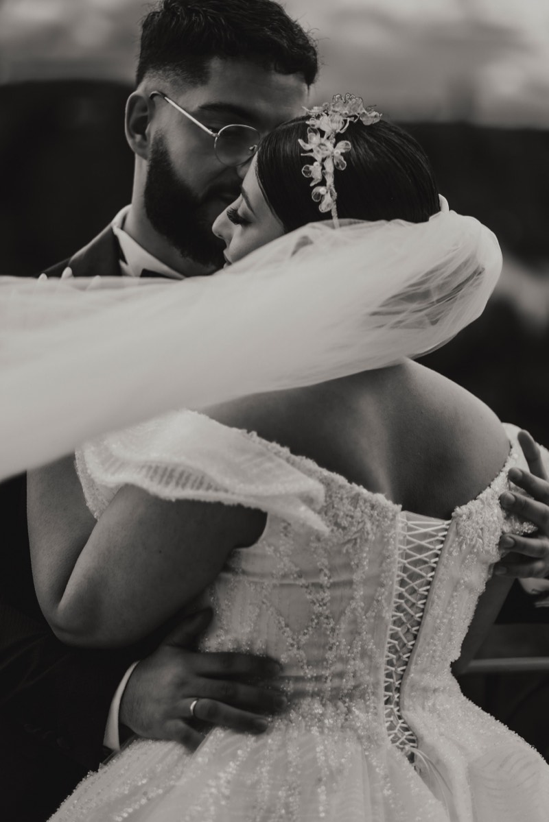 Groom fastening his cuff before the ceremony.